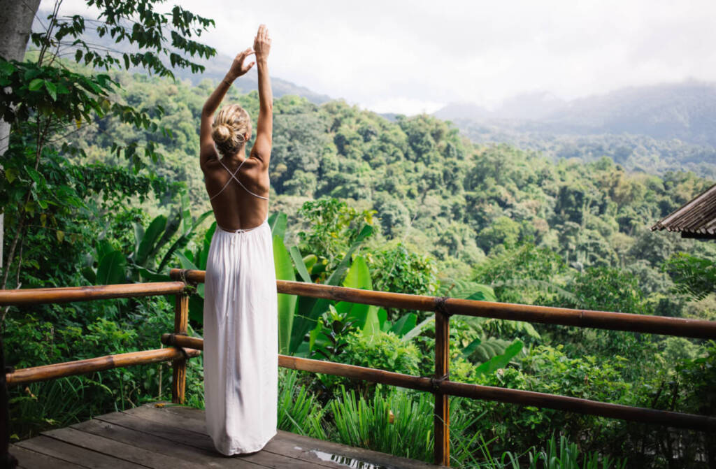 Woman stretchig in tropical forest